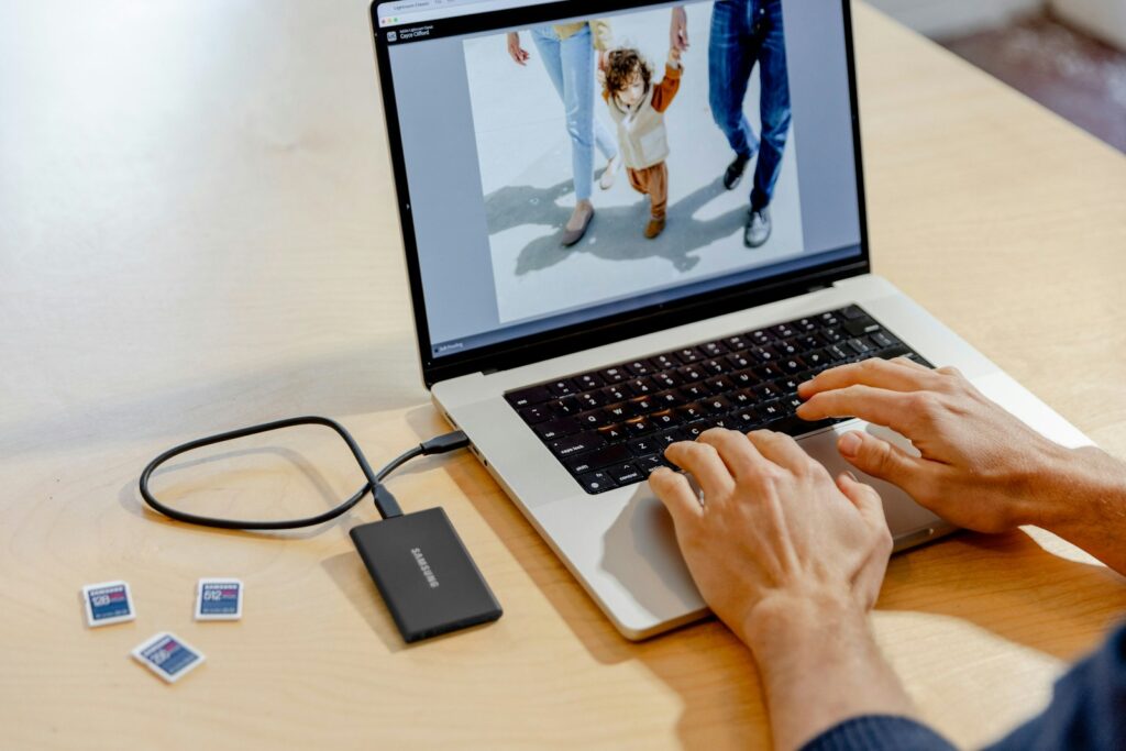 A person using a laptop computer on a table